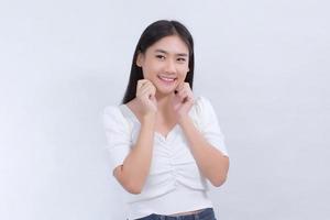 Portrait Asian pretty girl with long hair is smiling and touching her face on white background. photo