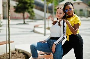 White caucasian girl and black African American together. World unity, racial love, understanding in tolerance and races diversity cooperation. photo