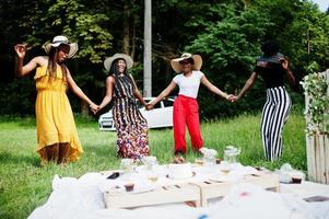 Group of african american girls celebrating birthday party having fun and dancing outdoor with decor. photo