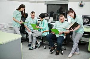 Medical theme.Observation room with a computer tomograph. The group of doctors meeting in the mri office at diagnostic center in hospital. photo