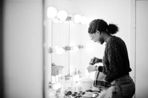 African American woman make-up artist at beauty saloon. photo