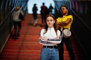 White caucasian girl and black African American together on tonnel. World unity, racial love, understanding in tolerance and races diversity cooperation. photo