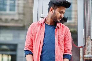 Portrait of young stylish indian man model pose in street. photo