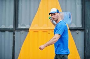 Delivery man carrying water bottle on shoulder. photo