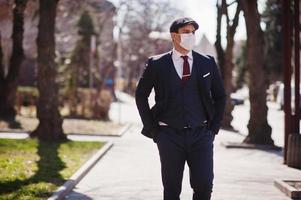 Concept of coronavirus quarantine. Business man wear on suit with medical face mask. MERS-Cov, Novel coronavirus 2019-nCoV photo