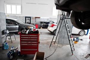 Car repair and maintenance theme. Cars in auto service. photo