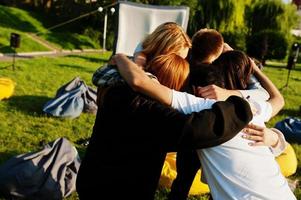 Young multi ethnic group of people in open air cinema. photo