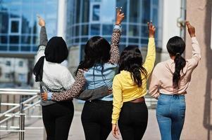 Back view of four young college african american woman friends spend time together. photo