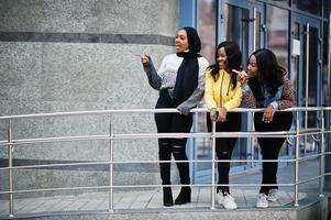 Three young college african american woman friends spend time together. photo