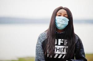 African girl at park wearing medical masks protect from infections and diseases coronavirus virus quarantine. photo