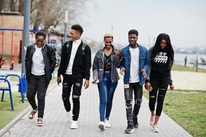 Young millennials african friends walking in city. Happy black people having fun together. Generation Z friendship concept. photo