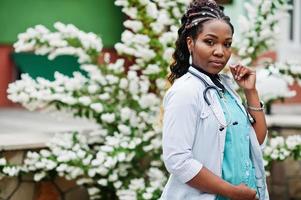 retrato de una doctora afroamericana con estetoscopio usando bata de laboratorio. foto