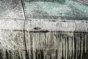 washing the car with foam close up photo