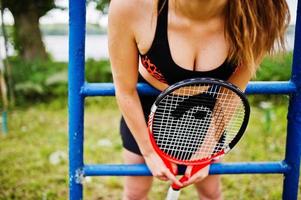 Beautiful sport woman tennis player with racket in sportswear costume. photo