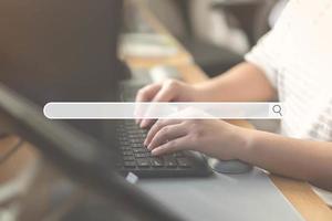 Close up of human hand typing on computer keyboard as background of search engine browser photo