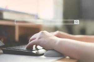 Close up of human hand typing on computer keyboard as background of search engine browser photo