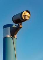 Security camera in front of blue sky photo