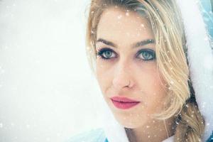 Beautiful young woman in winter snow photo