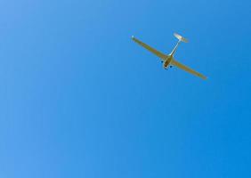 propeller plane in the cloudless blue sky photo