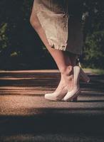 Woman in skirt wearing stylish beige shoes photo