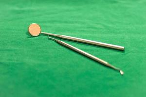 dentist instruments on a green cloth photo