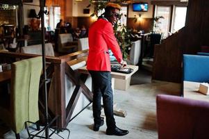 Fashion african american man model DJ at red suit with dj controller. photo