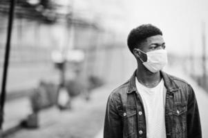 African man at park wearing medical masks protect from infections and diseases coronavirus virus quarantine. photo