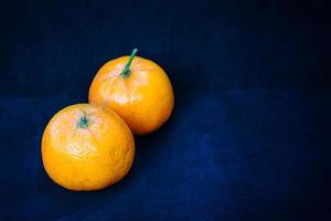 Two oranges on blue photo