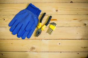 Tools and gloves on wooden table photo