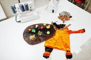 disfraz de niño hecho a mano de carnaval infantil en la oficina de costureras en el lugar de trabajo. foto