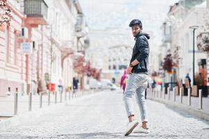 Portrait of young stylish indian man model pose in street. photo