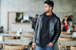 Portrait of stylish and casual young asian man wear on leather jacket spending time at cafe. photo