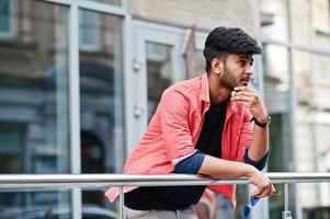 Portrait of young stylish indian man model pose in street. photo