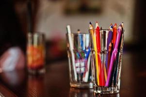 Pencils in glass for drawing on a table. photo