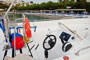Yacht steering wheel motor boat on a calm blue sea of Bodrum, Turkey. photo