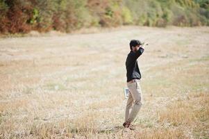 South asian agronomist farmer inspecting wheat field farm. Agriculture production concept. photo