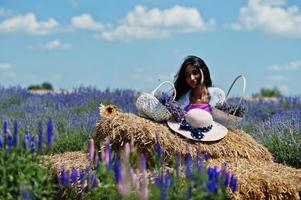 Beautiful indian girl wear saree india traditional dress in purple lavender field. photo