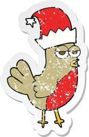 retro distressed sticker of a cartoon robin in christmas hat vector