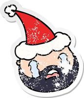 distressed sticker cartoon of a male face with beard wearing santa hat vector