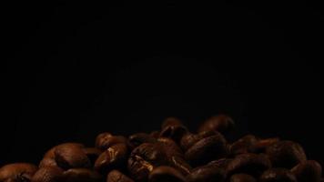 Slow motion of roasted coffee beans falling. Organic coffee seeds. video