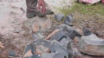 the hand of a worker who is moving a stone video