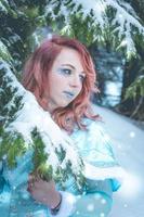 Attractive red haired woman in winter cape photo