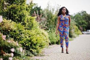 African american girl in coloured clothes posed outdoor. Fashionable black woman. photo