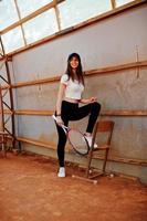 Young sporty girl player with tennis racket on tennis court. photo