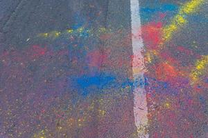 Colorful Holi powder scattered on a road photo