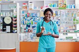African american pharmacist working in drugstore at hospital pharmacy. African healthcare. photo