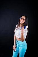 Portrait of a happy woman posing with passport and glasses. photo