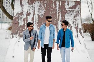 Group of three casual young indian mans in sunglasses posed at winter day. photo