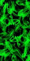 Abstract green smoke on black background photo