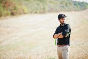 South asian agronomist farmer inspecting wheat field farm. Agriculture production concept. photo